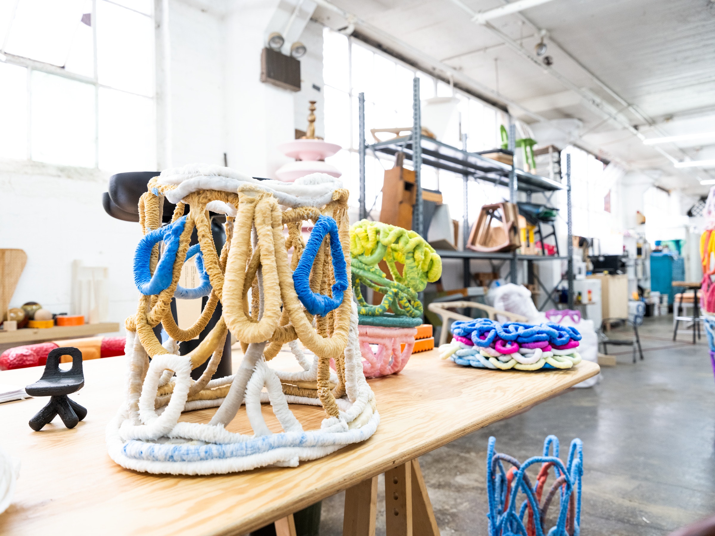 Brightly colored sculpture in a studio.