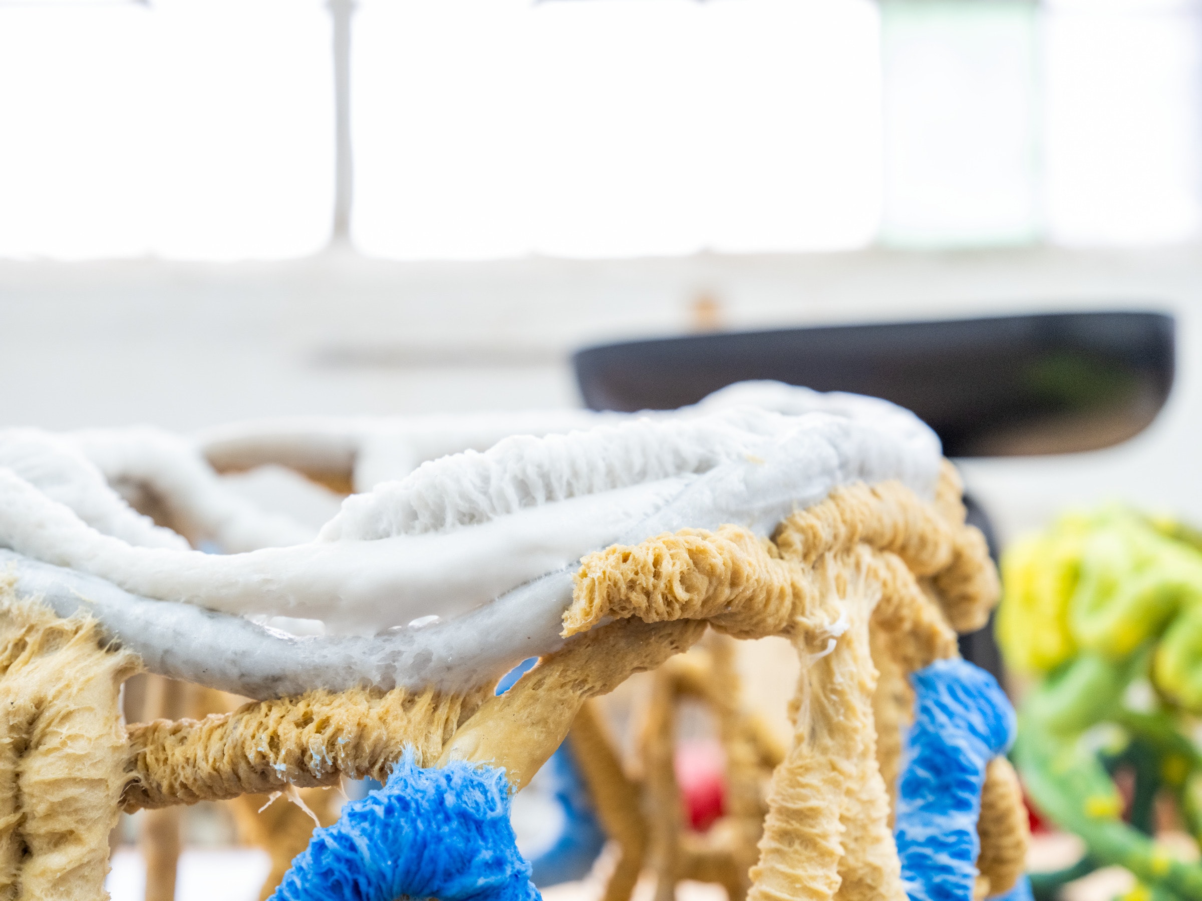 Brightly colored sculpture in a studio.